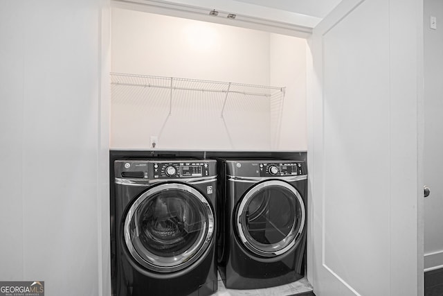 clothes washing area with washing machine and dryer