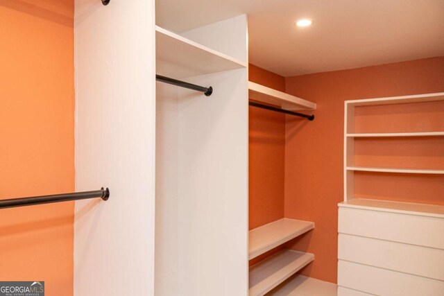 bathroom with tiled shower and hardwood / wood-style flooring