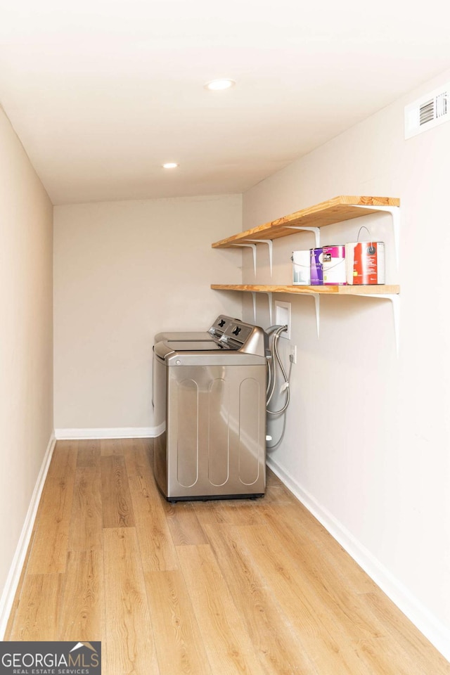 washroom featuring separate washer and dryer and light wood-type flooring