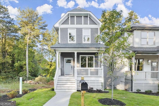 view of front of home featuring covered porch and a front lawn