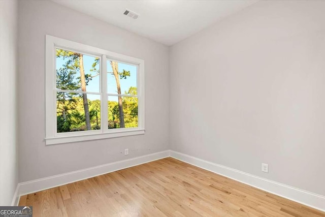 unfurnished room with light wood-type flooring