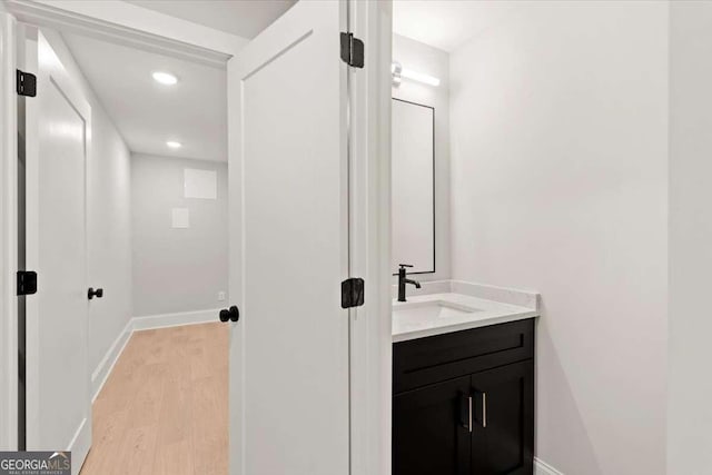 bathroom with hardwood / wood-style floors and vanity