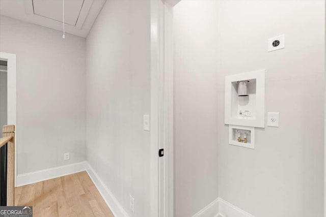 laundry area featuring electric dryer hookup, hookup for a washing machine, and hardwood / wood-style floors