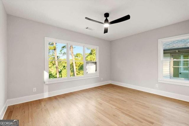 unfurnished room with ceiling fan and light wood-type flooring