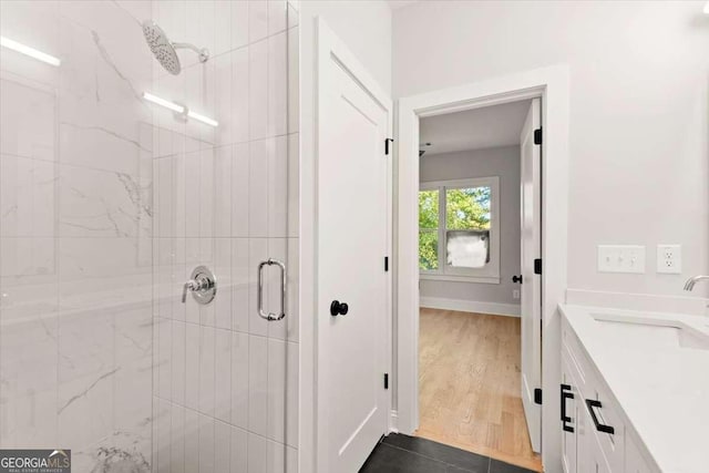 bathroom with vanity, an enclosed shower, and hardwood / wood-style flooring