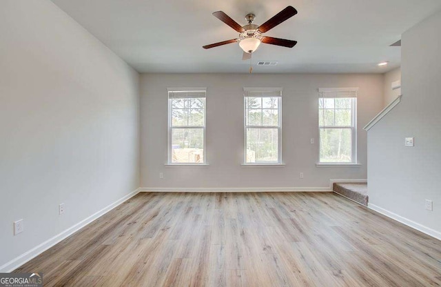 unfurnished room featuring ceiling fan and light hardwood / wood-style flooring