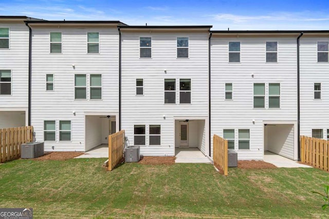 rear view of house featuring a patio area, a yard, and cooling unit