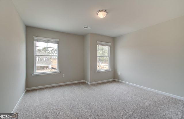 spare room with light colored carpet