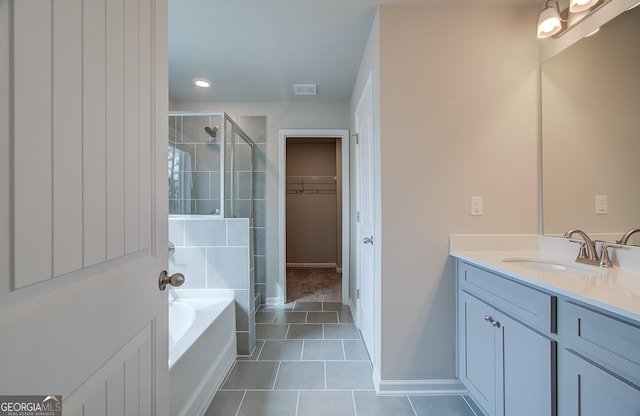 bathroom featuring tile patterned floors, vanity, and separate shower and tub