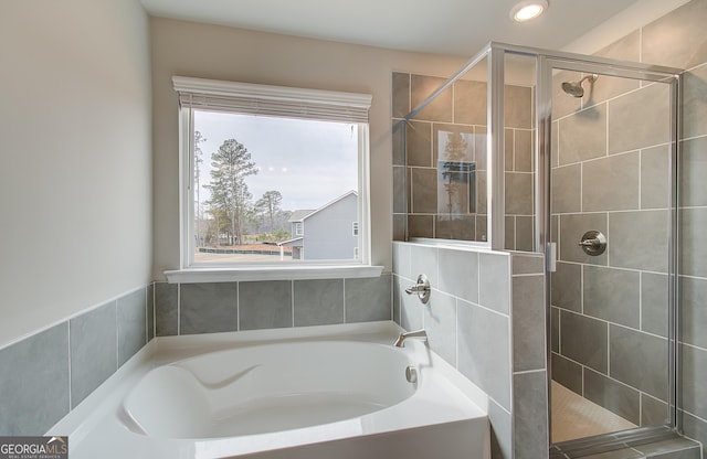 bathroom with separate shower and tub