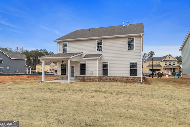 back of house with a yard, a patio, and ceiling fan