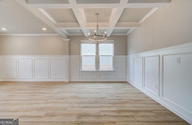 unfurnished dining area with beam ceiling, light hardwood / wood-style floors, coffered ceiling, and an inviting chandelier