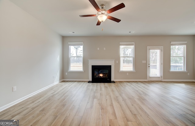 unfurnished living room with ceiling fan and light wood-type flooring