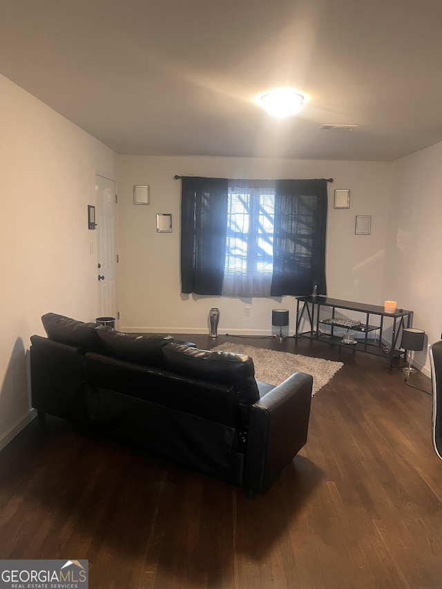 living room featuring dark wood-type flooring