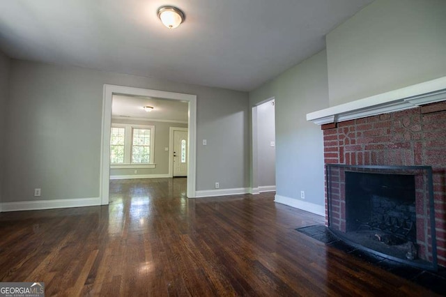 unfurnished living room featuring a fireplace and dark wood-type flooring