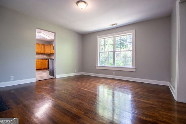 unfurnished living room with dark hardwood / wood-style floors