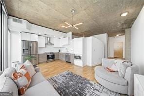 living room with a chandelier and light wood-type flooring