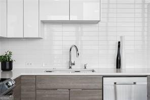 kitchen with sink, white cabinets, and range