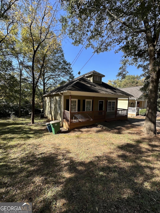 rear view of house with a yard