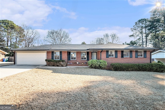 ranch-style home with a garage, concrete driveway, and brick siding