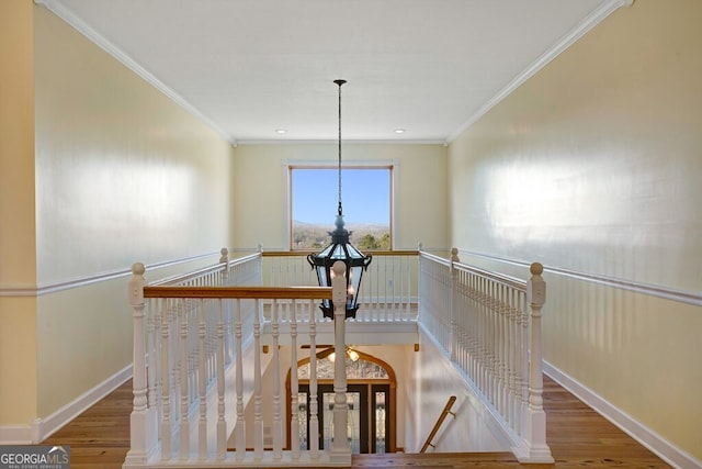 hallway with hardwood / wood-style flooring and ornamental molding