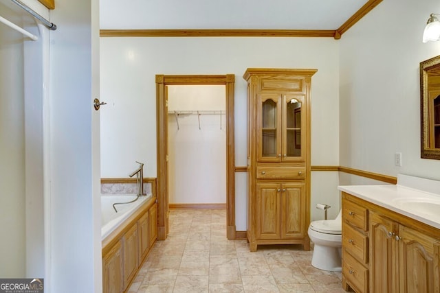 bathroom featuring a washtub, vanity, toilet, and ornamental molding