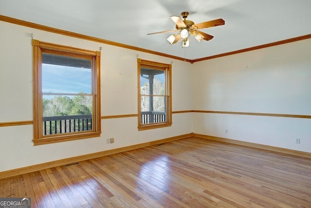 empty room featuring light wood-type flooring, ceiling fan, and ornamental molding