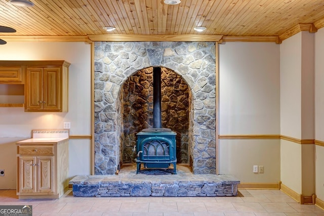 interior details with a wood stove, crown molding, and wood ceiling