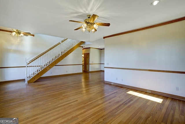 interior space featuring ceiling fan, hardwood / wood-style flooring, and ornamental molding