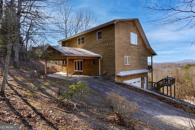 rear view of house featuring a garage