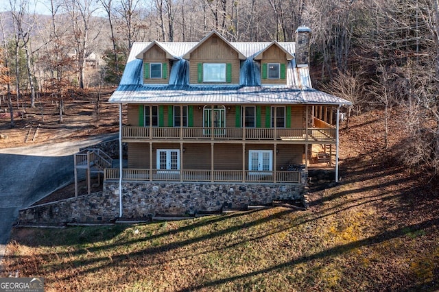 back of property featuring a lawn and french doors