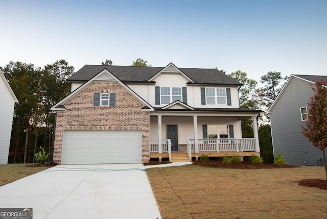 view of front of property with covered porch, a front yard, and a garage