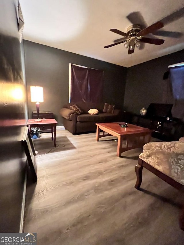 living room featuring ceiling fan and wood-type flooring