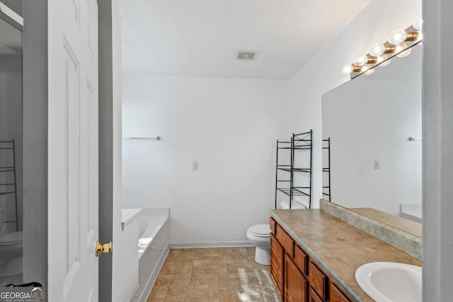 bathroom featuring vanity, a bath, and toilet