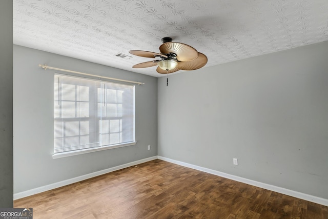 spare room with hardwood / wood-style flooring, ceiling fan, and a textured ceiling