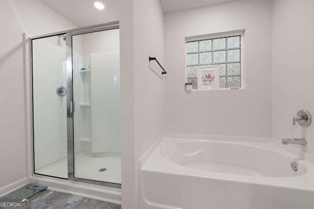 bathroom with separate shower and tub