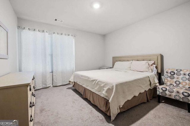 bedroom featuring light carpet