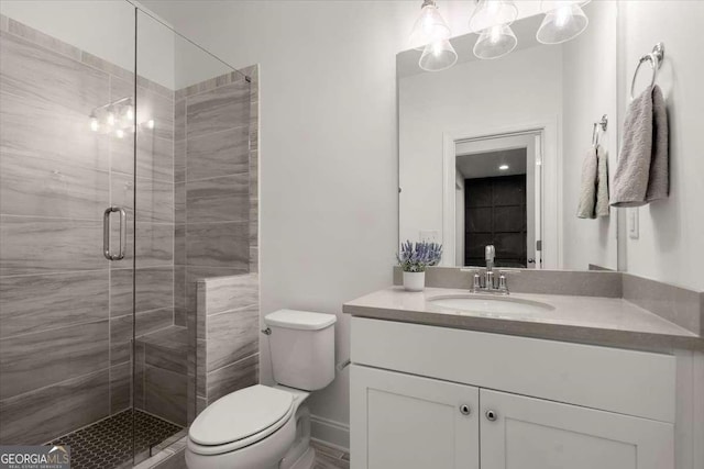 bathroom featuring vanity, toilet, and walk in shower