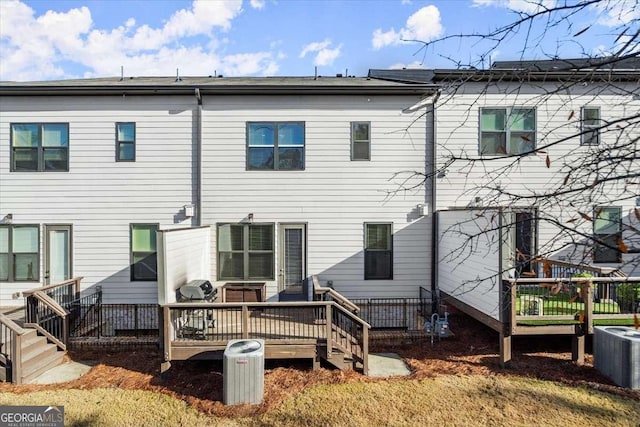 back of house with central AC and a wooden deck