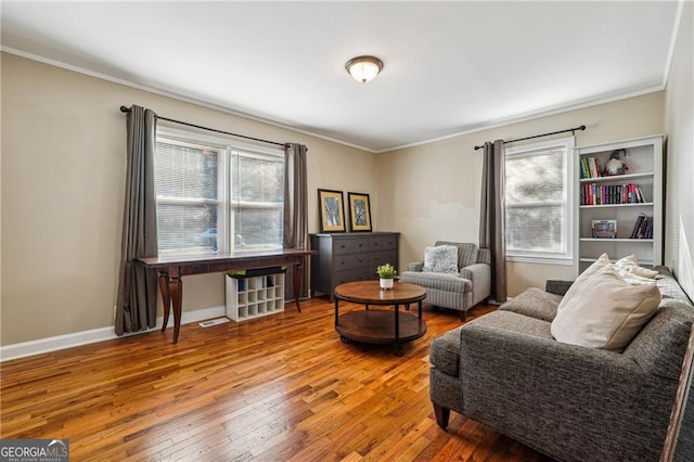 living area featuring hardwood / wood-style flooring and crown molding