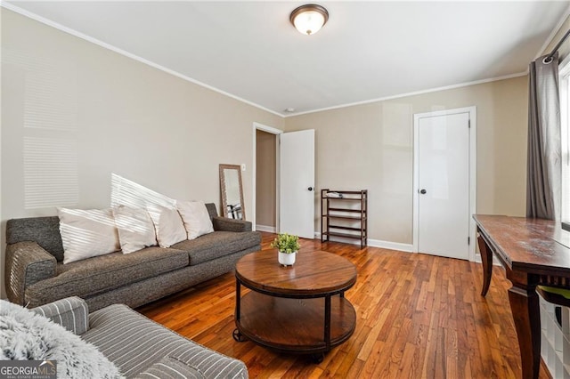 living room with hardwood / wood-style flooring and ornamental molding