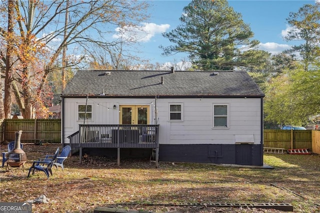 back of house with a wooden deck and an outdoor fire pit