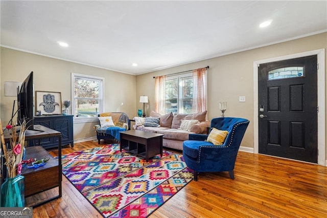 living room featuring ornamental molding and wood-type flooring