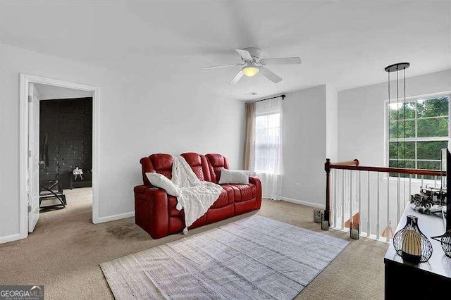 carpeted living room with ceiling fan