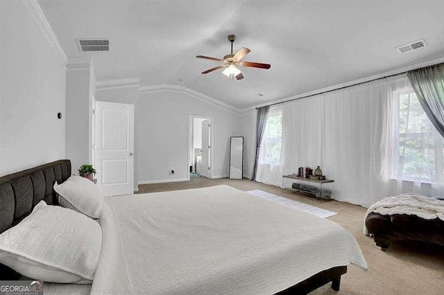 bedroom featuring light carpet, vaulted ceiling, ceiling fan, and crown molding