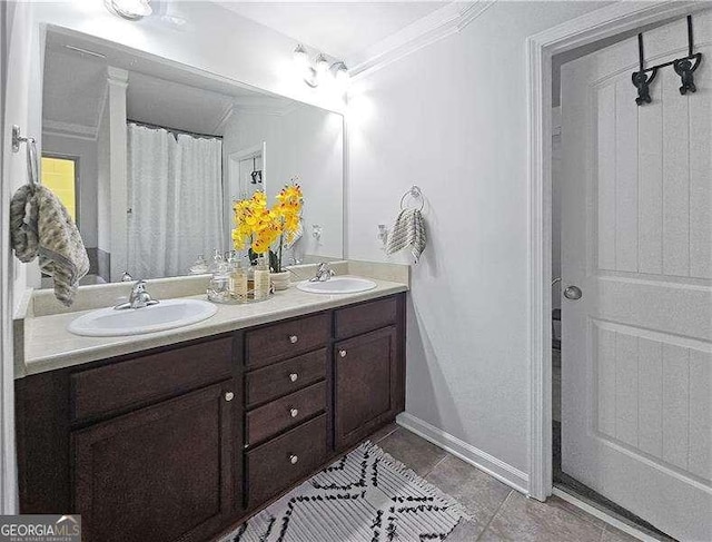 bathroom featuring tile patterned floors, vanity, and crown molding