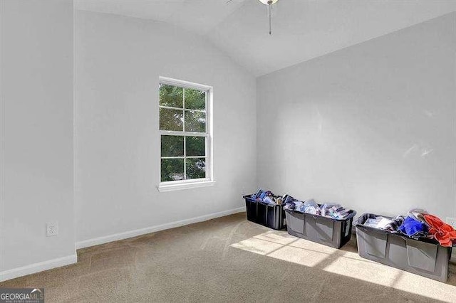 carpeted empty room with vaulted ceiling