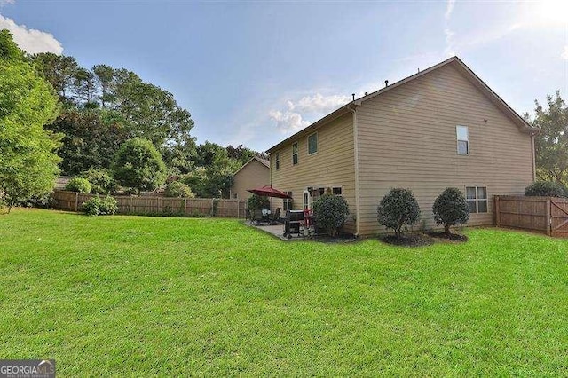 view of property exterior with a yard and a patio area