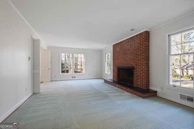 unfurnished living room with a fireplace, light colored carpet, and ornamental molding