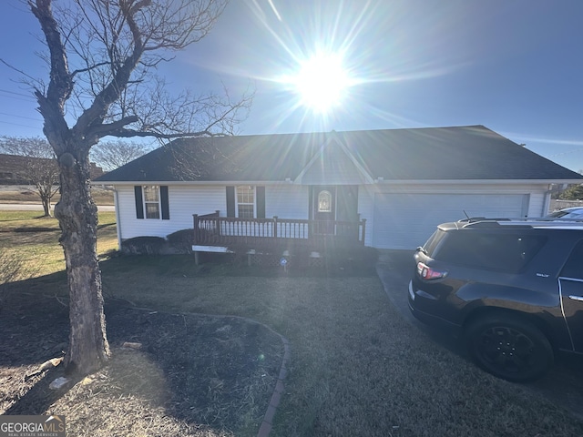 single story home with a deck and a garage